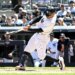 New York Yankees player Trent Grisham swings at a baseball during a game.