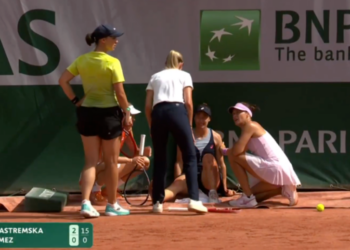 Two tennis players, a referee, and a trainer on a clay court with a score graphic for Kalinina and Yastremska.