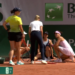 Two tennis players, a referee, and a trainer on a clay court with a score graphic for Kalinina and Yastremska.