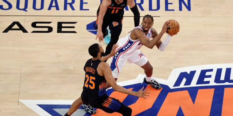 Mikal Bridges and Jalen Brunson trip Tyrese Maxey during the Knicks' win over the 76ers.