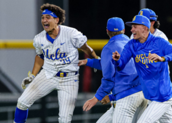 A jubilant Mulivai Levu (right) is set to get mobbed by teammates after hitting the game-winning 
sacrifice fly in the ninth inning of UCLA's 4-3 win over Purdue in the Big Ten quarterfinals on May 22, 2026 in Omaha, Neb.