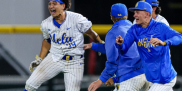 A jubilant Mulivai Levu (right) is set to get mobbed by teammates after hitting the game-winning
sacrifice fly in the ninth inning of UCLA's 4-3 win over Purdue in the Big Ten quarterfinals on May 22, 2026 in Omaha, Neb.
