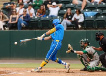 Roch Cholowsky hitting a baseball during a game.