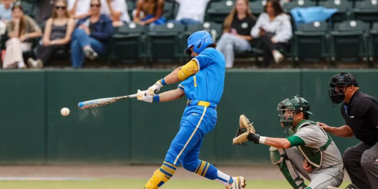 Roch Cholowsky hitting a baseball during a game.