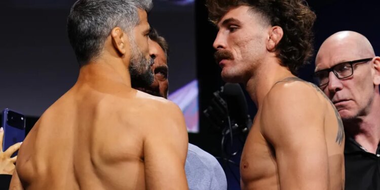 Beneil Dariush and Quillan Salkilld face off at the ceremonial weigh-in.