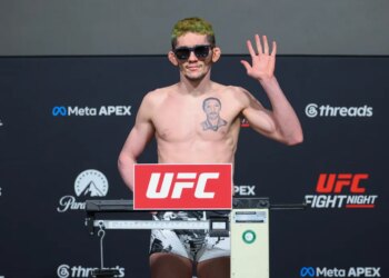 Melquizael Costa poses on the scale during the official weigh-in for UFC Fight Night.