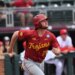 Andrew Lamb from the Trojans baseball team looking up while running.