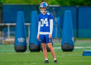 Dominic Zvada in New York Giants uniform #34 with a helmet on a practice field.