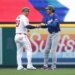 Shohei Ohtani of the Los Angeles Dodgers and Mike Trout of the Los Angeles Angels interact on the field.