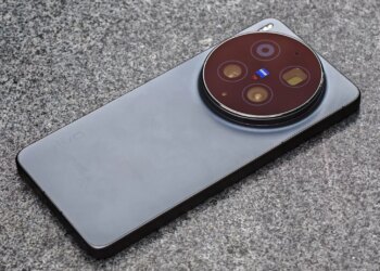 Photo of the Vivo X300 Ultra laying on a gray stone bench.