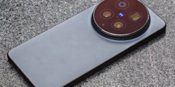 Photo of the Vivo X300 Ultra laying on a gray stone bench.