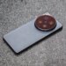 Photo of the Vivo X300 Ultra laying on a gray stone bench.