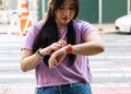 Person looking at Fitbit Charge 6 on their wrist.