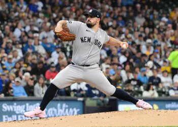 New York Yankees starting pitcher Carlos Rodon (55) throws a pitch in the first inning against the Milwaukee Brewers at American Family Field.