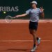 Zachary Svajda hitting a forehand return during a tennis match at the French Open.