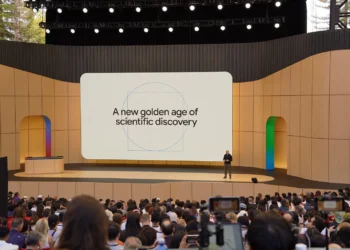 A picture of Demis Hassabis onstage at Google I/O 2026 with the screen behind him saying “A new golden age of scientific discovery”