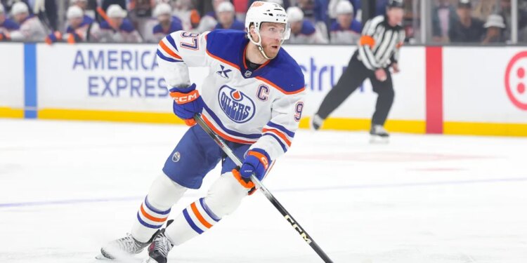 FILE - Edmonton Oilers center Connor McDavid moves the puck during the first period of an NHL hockey game against the Los Angeles Kings April 11, 2026 in Los Angeles. (AP Photo/Ryan Sun, File)