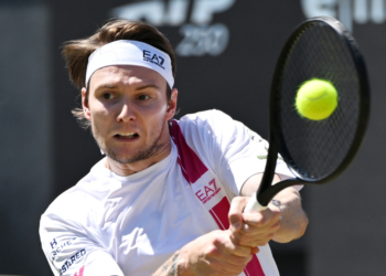 Kazakhstan's Alexander Bublik hitting a tennis ball during a men's singles semifinal match.