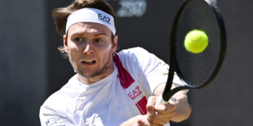 Kazakhstan's Alexander Bublik hitting a tennis ball during a men's singles semifinal match.