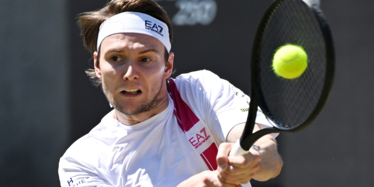 Kazakhstan's Alexander Bublik hitting a tennis ball during a men's singles semifinal match.