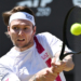 Kazakhstan's Alexander Bublik hitting a tennis ball during a men's singles semifinal match.