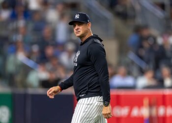 New York Yankees manager Aaron Boone reacts as he walks back to the dugout.