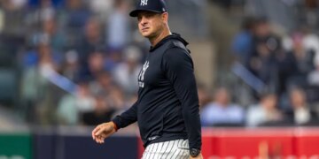 New York Yankees manager Aaron Boone reacts as he walks back to the dugout.