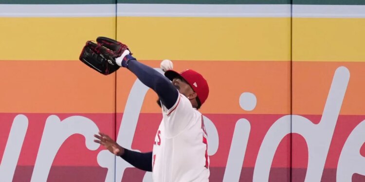 Los Angeles Angels right fielder Jo Adell misplays a ball hit by Colorado Rockies' TJ Rumfield that hit him in the head and then bounced out for a solo home run during the fourth inning of a baseball game Tuesday, June 2, 2026, in Anaheim, Calif.