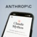 A smartphone displaying "Claude Mythos" by Anthropic on its screen.