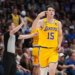 Lakers player Austin Reaves pointing to his head during a game.