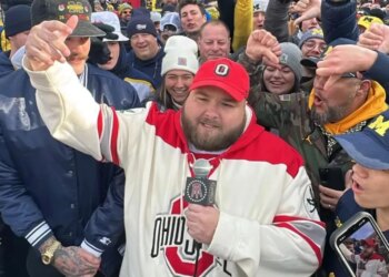 Big Ev from Barstool Sports speaking into a microphone, surrounded by a crowd.