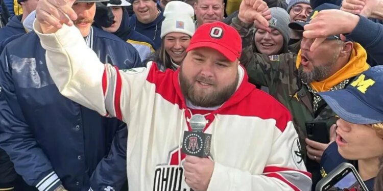 Big Ev from Barstool Sports speaking into a microphone, surrounded by a crowd.