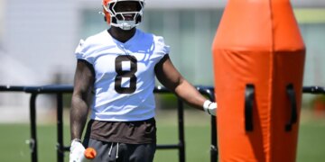 Cleveland Browns defensive end Jared Verse stands on the field during practice.