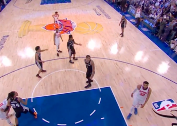 Basketball players on a court during a game.