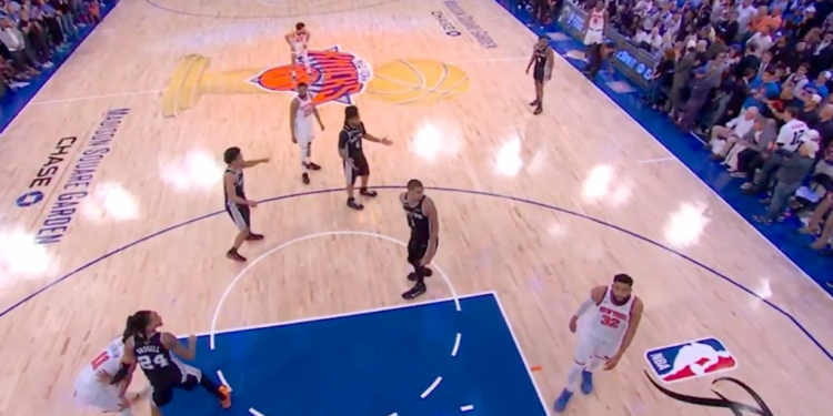 Basketball players on a court during a game.