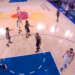 Basketball players on a court during a game.