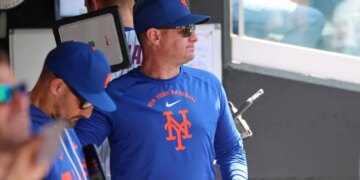 New York Mets manager Carlos Mendoza #64 in the dugout.