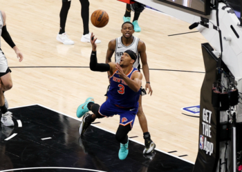 New York Knicks guard Josh Hart (3) and San Antonio Spurs guard De'aaron Fox (4) look for the ball during game five of the 2026 NBA Finals at Frost Bank Center.