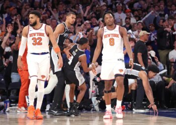 New York Knicks center Karl-Anthony Towns #32 and forward Og Anunoby #8 react on the court as San Antonio Spurs players walk by during the NBA Finals Game 3.