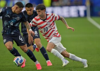 United States' Christian Pulisic (10) runs with the ball during the World Cup Group D soccer match against Paraguay.