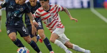 United States' Christian Pulisic (10) runs with the ball during the World Cup Group D soccer match against Paraguay.
