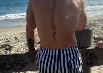Conor McGregor on the beach looking out at the ocean.