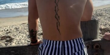 Conor McGregor on the beach looking out at the ocean.