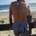 Conor McGregor on the beach looking out at the ocean.