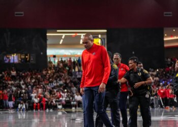 Washington Mystics coach Sydney Johnson is escorted off the court by police after being ejected during a game against the Dream on June 6, 2026.