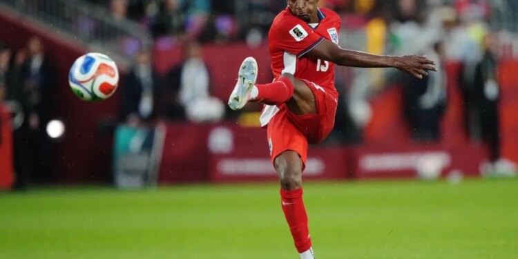 Jiovany Ramos of Panama kicking a soccer ball during a World Cup match.
