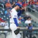 New York Mets pitcher David Peterson adjusts his hat after giving up a 2-run home run.