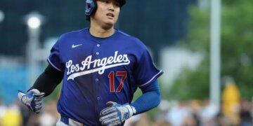 Shohei Ohtani of the Los Angeles Dodgers running on the field in a blue uniform with the number 17.