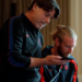 Two men in athletic wear looking at a phone.