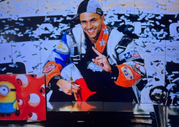 San Antonio Spurs legend Tony Parker poses in a racing jacket with confetti falling in the background. ESPN is under scrutiny after using this AI-generated image during Game 1 of the NBA Finals Wednesday night.